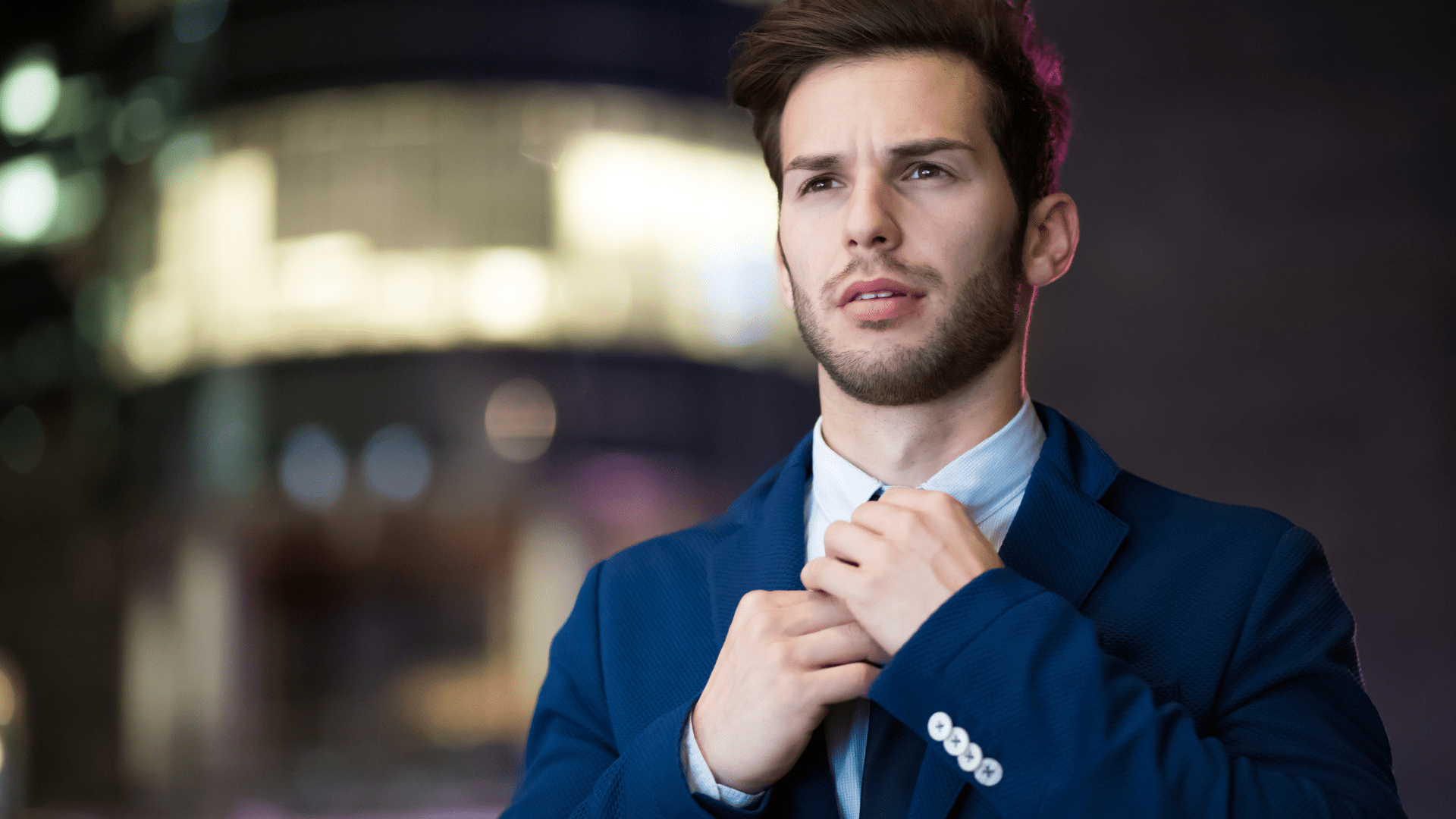 Confident young man adjusting tie, symbolizing the neuroscience of trusting your decisions with clarity and self-assurance.