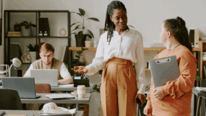 “Leader mentoring team members in a supportive office, demonstrating positivity in Dopamine-Aware Leadership.”