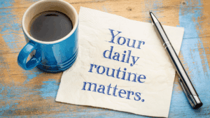 “Coffee cup and note reading your daily routine matters, symbolizing habit formation in Dopamine-Aware Leadership.”