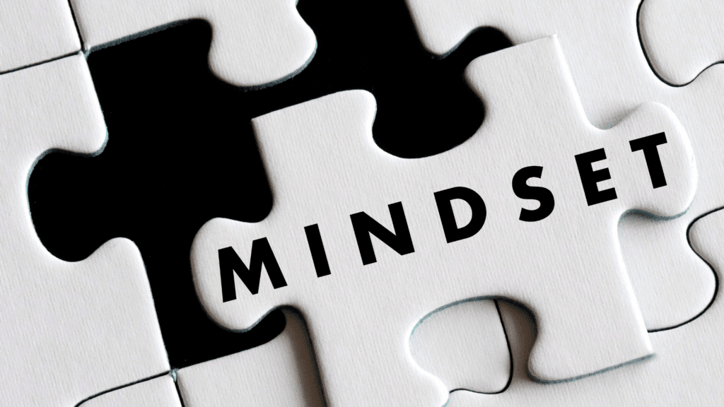 White puzzle piece with MINDSET text fitting into black puzzle background representing neuroscience based mindset coaching integration