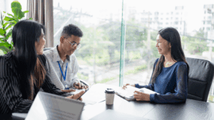 “Business professionals smiling during an interview, symbolizing leadership development through Neuroscience-Based Executive Coaching.”