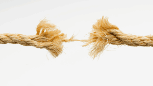 Frayed rope on the verge of breaking, symbolizing emotional tension and why men struggle with intimacy.