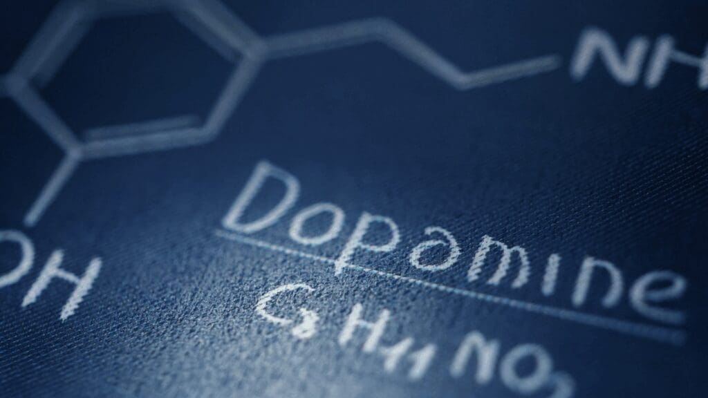 Close-up view of dopamine neurotransmitter chemical structure and formula displaying the molecular composition underlying dopamine coaching mechanisms.
