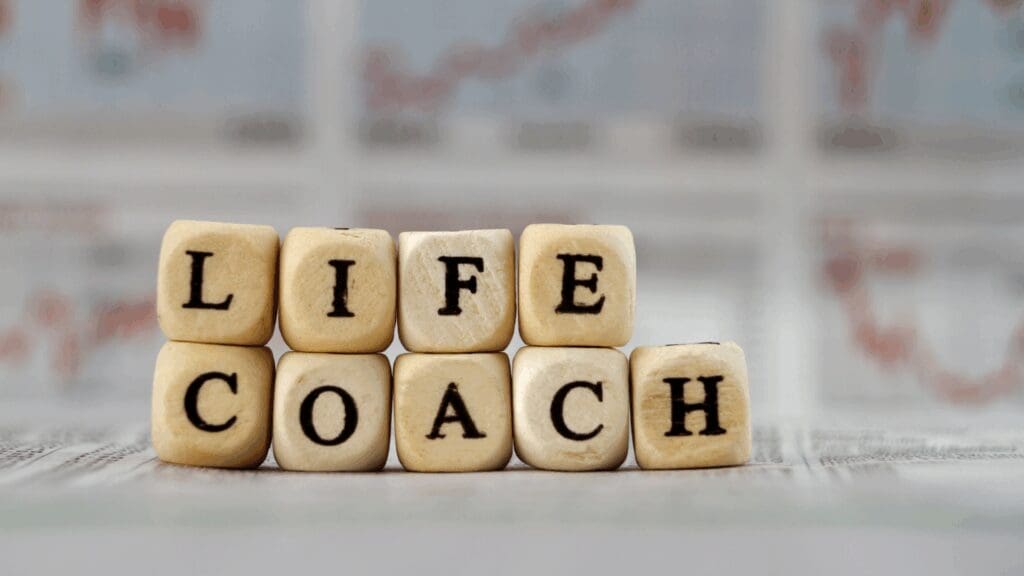 Wooden blocks spelling life coach representing traditional life coaching vs neuroscience coaching approaches