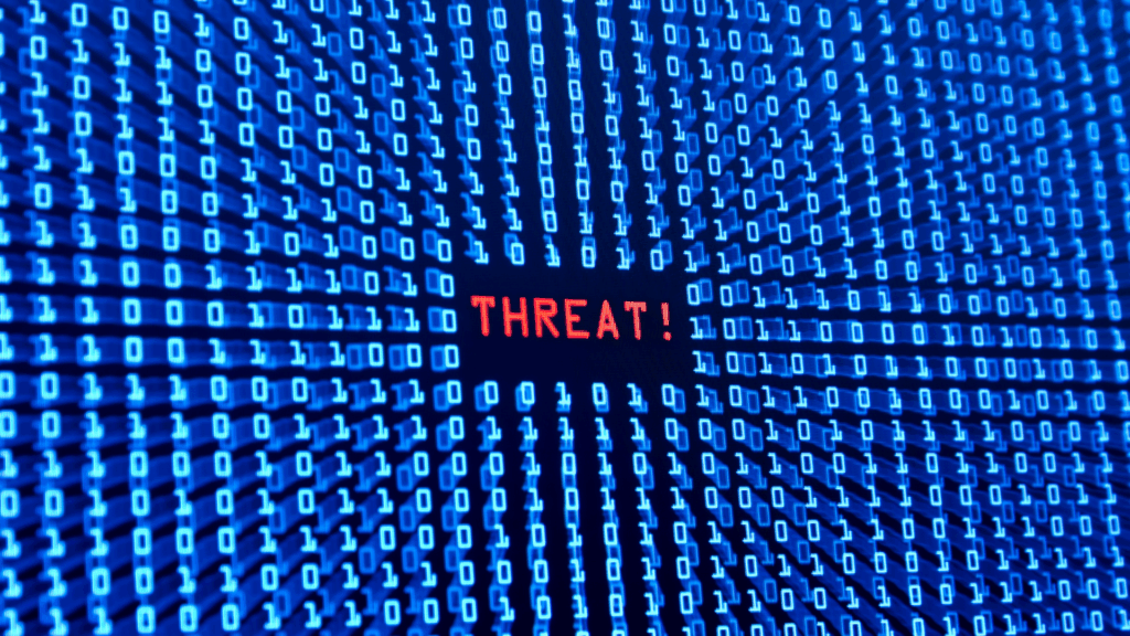 Red threat alert in binary code representing how amygdala detects threats in life coaching vs neuroscience coaching stress management

