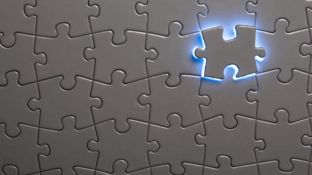 Illuminated puzzle piece shaped like human head representing complete solution in life coaching vs neuroscience coaching