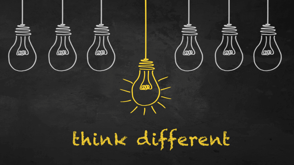 Yellow illuminated lightbulb standing out representing think different approach to life coaching vs neuroscience coaching