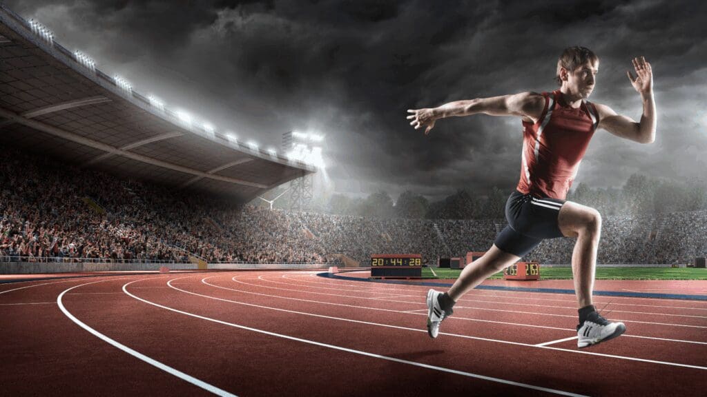 Track athlete sprinting focused on peak performance through neuroscience of performance coaching methods.