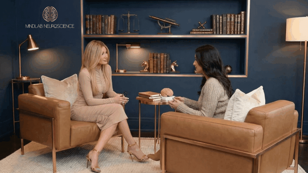  Dr. Sydney Ceruto founder of MindLAB Neuroscience working with a client in her office sitting across from one another.