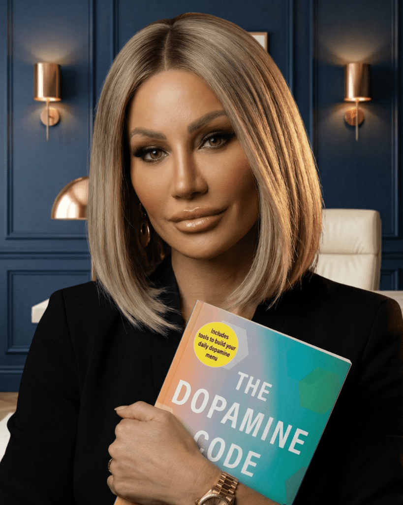 Dr. Sydney Ceruto Author The Dopamine Code published by Simon & Schuster holding a copy of the book in a luxury office